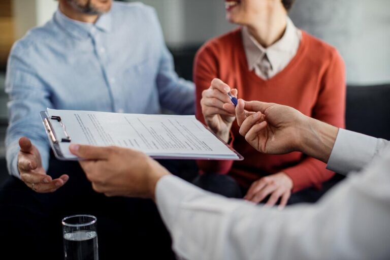 closeup-unrecognizable-couple-signing-contract-with-financial-advisor_637285-11092