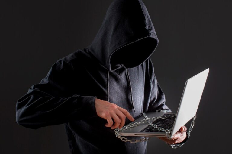 male-hacker-with-laptop-protected-by-chain_23-2148578163