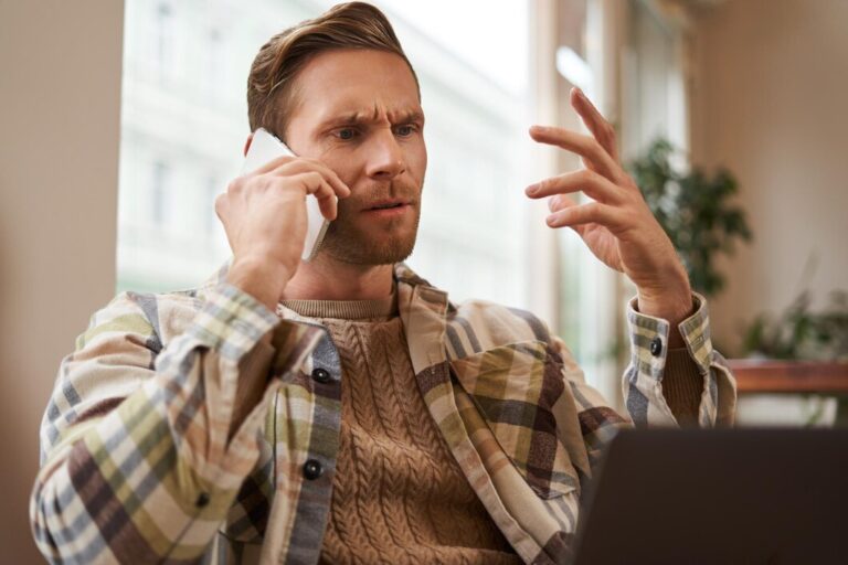 portrait-confused-man-arguing-with-someone-phone-businessman-discuss-project-looking_1258-245381
