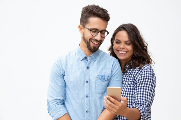 smiling-young-couple-using-smartphone_74855-4072